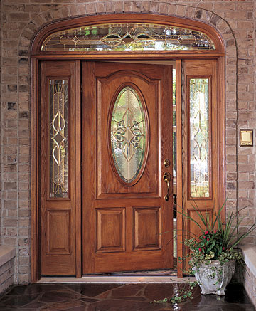 Wood-grain fiberglass entry door with decorative glass and sidelites