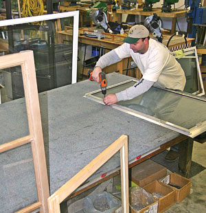 Truax craftsman building a custom storm window in the shop