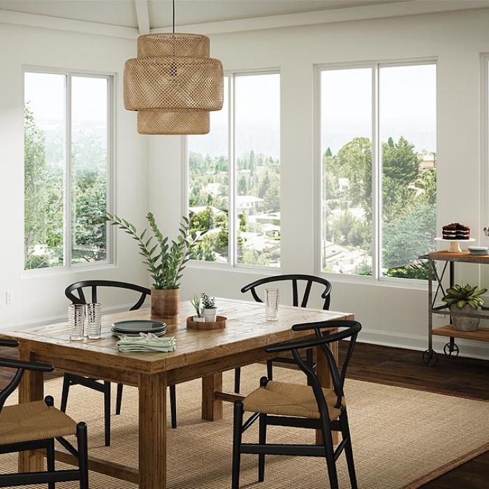 Bright dining room with white Milgard sliding windows